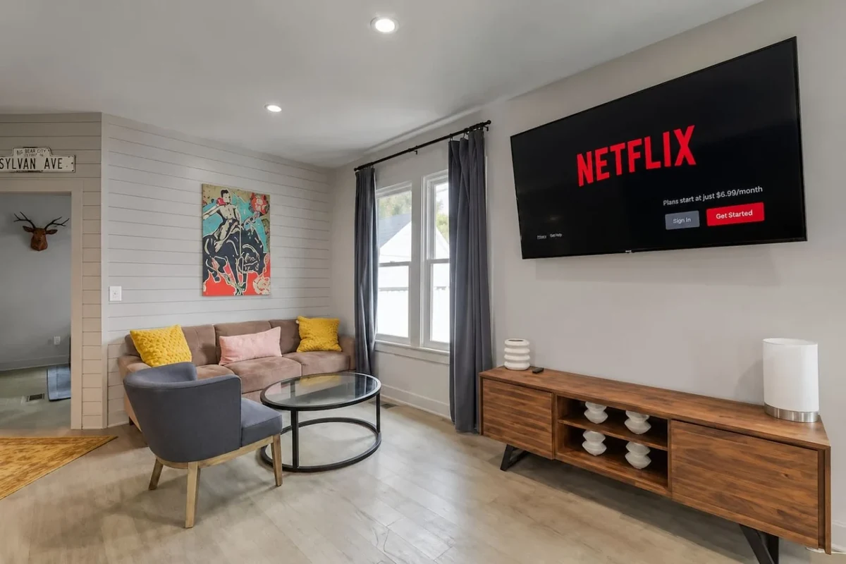 823 Sylvan living room with sofa, chairs, artwork and television